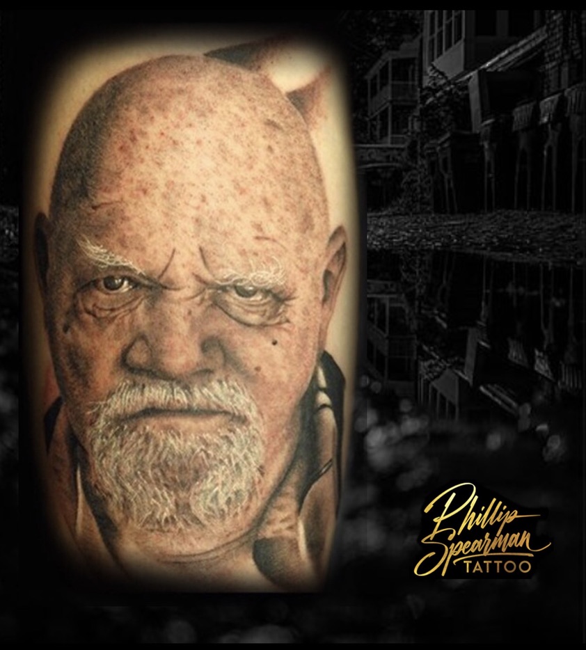 This black and grey portrait offers a powerful likeness, capturing the subject’s distinct character with remarkable depth. Phillip’s precision is evident in the finely rendered wrinkles around the eyes and the detailed texture of the white beard, where smooth tonal transitions and deep contrast create striking dimensionality. The piece holds a living presence, subtly hinting at a mythic strength woven into its very form.