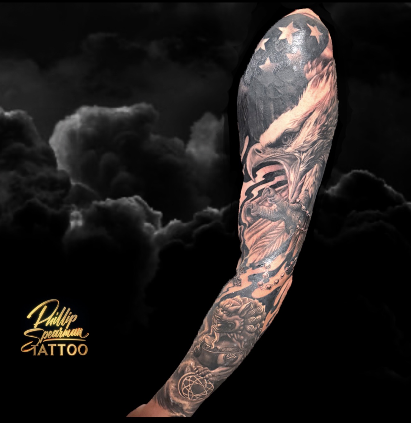 This black and grey sleeve builds a powerful narrative with its luminous depth, featuring a majestic eagle and a protective Foo Dog. Phillip's detailed execution brings these elements to life through smooth tonal transitions and stark contrasts, visible in the intricate texture of the eagle's feathers and the subtle shading on each rosary bead. It thoughtfully reflects the profound stories and convictions that shape a life, a true personal atlas on the skin.