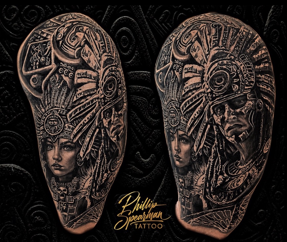 This powerful black and grey sleeve showcases an Aztec King and Queen, artfully rendered to represent the client and his wife. Every intricate detail, from their majestic headpieces to the subtle DNA strand woven into the design, tells a story honoring his lineage with profound depth. It's a truly personal narrative brought to life with precision and care.