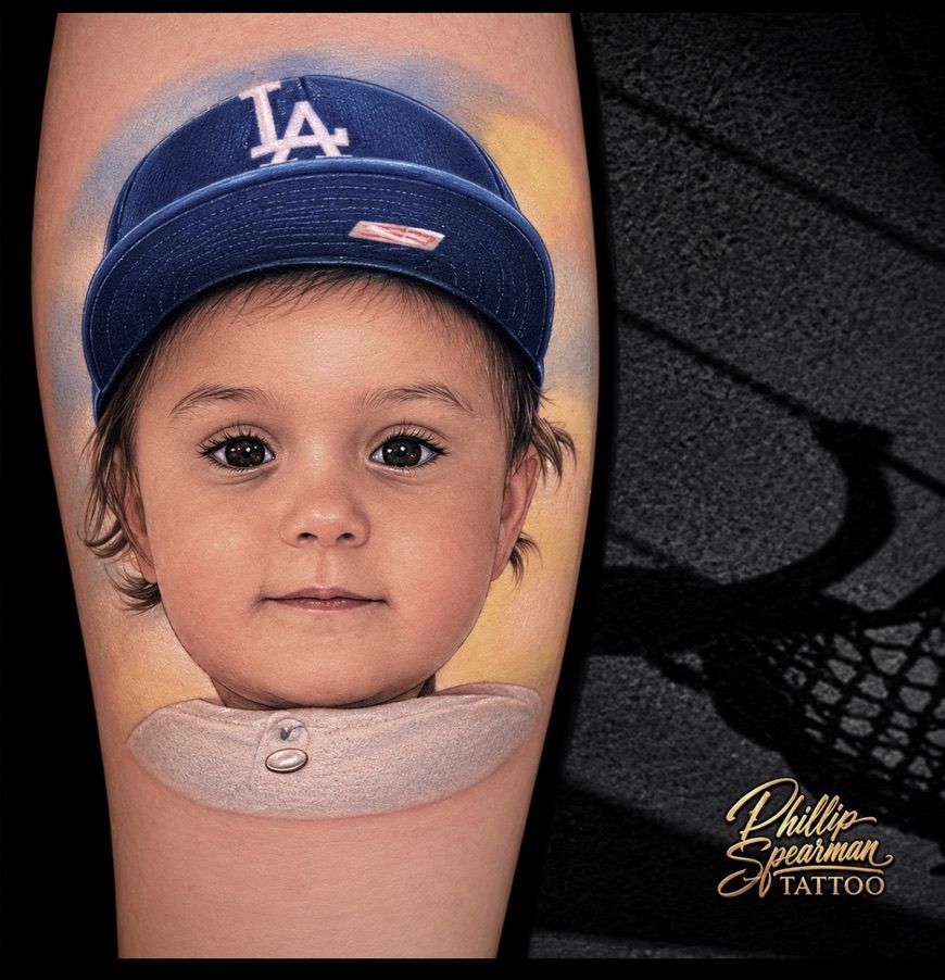 This vibrant color portrait captures the essence of a cherished son. Phillip's dedication to realism brings a tangible warmth to the piece, from the soft features of the child's face to the intricate texture of the Dodgers cap. The delicate rendering of each hair strand and the precise gleam in the eyes truly reflect a living moment.
