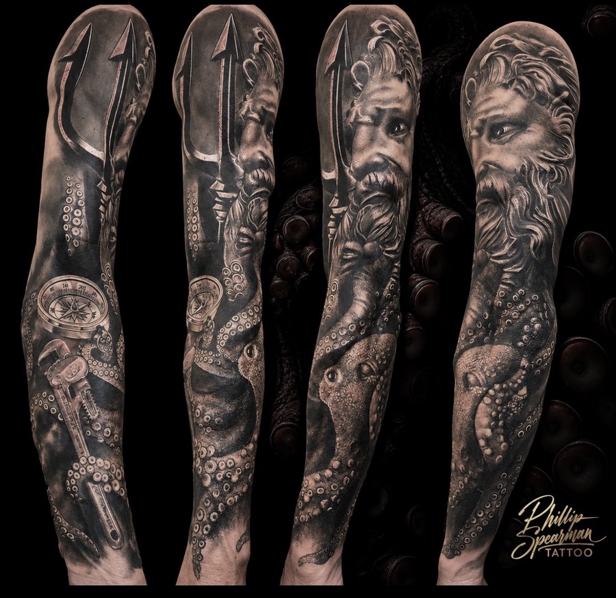 This striking black and grey sleeve tells a unique story, blending the might of the ocean with a personal legacy. At the shoulder, Poseidon's powerful form transitions into an octopus, its detailed tentacles wrapping around the arm. Further down, a finely rendered compass and a classic pipe wrench bring forward the client's deep connection to the sea and a cherished family trade.