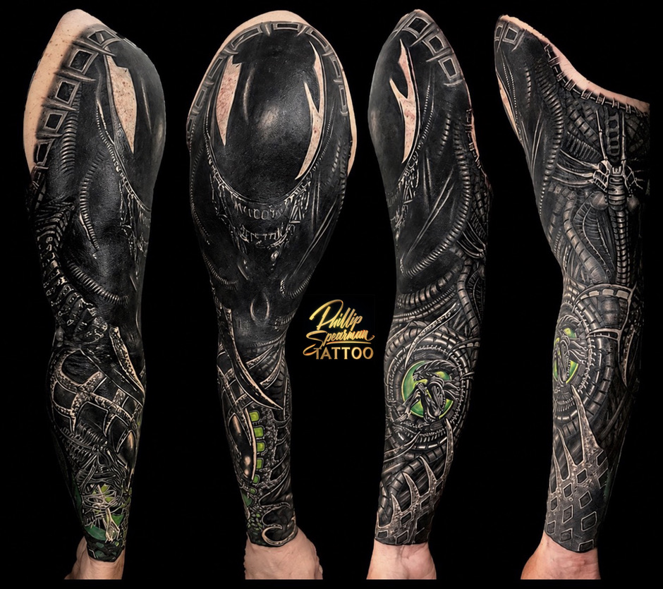 This Xenomorph sleeve is a true transformation, where a previous tattoo has been meticulously covered, leaving no trace of what was there before. Phillip has sculpted the arm with deep blacks and intricate biomechanical details, echoing the iconic forms of the Xenomorph's cinematic origins. The subtle green accents within the design bring an unsettling, vital energy to the entire composition.